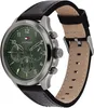 A close-up, side view of a Tommy Hilfiger men's watch with a green dial and a black leather strap. Produktbild-Vorschau