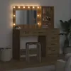 A vanity table with a mirror and lights, along with shelves and drawers, is shown in a room setting. Voir les images du produit