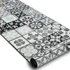 A rolled-up rug with a patchwork tile pattern. Produktbild-Vorschau