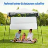 A family is having a picnic under a pop-up canopy in a park. Produktbild-Vorschau