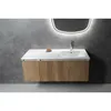 A modern bathroom vanity with a white countertop and sink, set against a textured gray wall. Produktbild-Vorschau