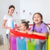 A woman and two young girls are playing in an inflatable play structure. Anteprima dell’immagine prodotto
