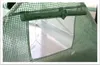 Close-up view of a green mesh greenhouse cover with a window opening and a support rod. Náhled obrázku produktu
