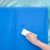 A hand is wiping water droplets off a blue mat. Náhľad obrázku produktu