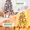 A split image showing a Christmas tree decorated with snow and ornaments during the day and at night with lights. Produktbild-Vorschau