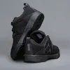 A pair of black shoes on a gray background. Podgląd zdjęcia produktu