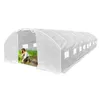 A woman is tending to plants inside a white greenhouse. Produktbild-Vorschau