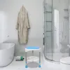 A bathroom scene with a shower stool, bathtub, and bathrobe. Produktbild-Vorschau
