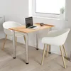 A small dining table with two chairs in a bright room with a window. Produktbild-Vorschau