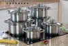 A set of stainless steel pots and pans on a black induction cooktop, with some ingredients like garlic, spaghetti, and chili peppers in the foreground. Náhled obrázku produktu