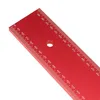 A close-up view of a red metal ruler with measurement markings. Podgląd zdjęcia produktu