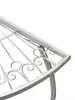 Close-up of the edge of a white metal table with decorative scrollwork. Produktbild-Vorschau