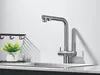 A kitchen faucet is shown in a studio-like setting with a sink and a small plant. Anteprima dell’immagine prodotto