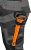 A close-up shot of a pair of work pants with a pipe wrench in a holster. Produktbild-Vorschau