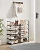 A shoe rack with various shoes and boots on display in a hallway, with a coat and bag hanging on a wall rack above. Produktbild-Vorschau