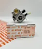 A carburetor is placed on top of its packaging box. Produktbild-Vorschau
