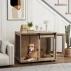 A golden retriever dog is lying inside a wooden dog crate that is styled as a piece of furniture. The crate is placed in a living room setting with a sofa and a potted cactus nearby. A staircase is visible in the background. Produktbild-Vorschau