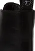 A close-up view of the top of a black leather boot. Produktbild-Vorschau