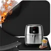 A black heat-resistant mat with flames in the corner, an air fryer, and a basket of french fries on a wooden board. Náhled obrázku produktu