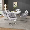 A dining room setting with a marble-top table and gray velvet chairs. Voir les images du produit