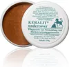 A white tub of Keralit Undercover Pflegepaste with its lid open, showing the brown paste inside. Produktbild-Vorschau