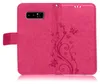 A pink phone case with a floral and butterfly embossed design. Produktbild-Vorschau