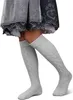 A person's legs wearing knee-high socks and a traditional dress. Produktbild-Vorschau