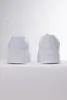 A pair of white Puma sneakers shown from the back on a white background. Produktbild-Vorschau
