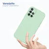 A hand holding a light green smartphone case against a white background. Produktbild-Vorschau