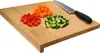 A wooden cutting board with chopped vegetables and a knife. Podgląd zdjęcia produktu