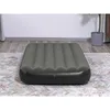 An inflatable mattress is placed on a rug in a room. Náhled obrázku produktu