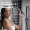 A woman is showering with a handheld shower head. Produktbild-Vorschau