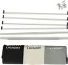 The image shows the components of a laundry basket organizer, including metal rods and fabric compartments, laid out on a white background. Produktbild-Vorschau