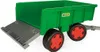 A green toy trailer with a gray ramp and red-rimmed black wheels, shown from a diagonal angle against a white background. Voir les images du produit