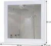 A white framed mirror with a shelf below, reflecting a shower. Produktbild-Vorschau