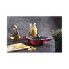 A red pot with a glass lid, a bottle of oil, a jar of pasta, and a cutting board with pasta on it, set against a textured gray background. Náhled obrázku produktu