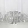 A close-up view of the bottom edge of white sheer curtains with a decorative silver trim made of rhinestones. Podgląd zdjęcia produktu