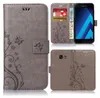 A collage of images showing a grey flip phone case with a floral pattern, a Samsung phone inserted, and card slots. Produktbild-Vorschau