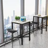 A bar table and stools set placed by a large window overlooking a city skyline. Náhľad obrázku produktu