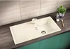 A kitchen sink with a faucet, drain, and a drying rack area, set against a tiled backsplash. Produktbild-Vorschau
