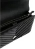 Close-up view of the interior and exterior of a black quilted handbag. Anteprima dell’immagine prodotto