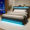 A modern bedroom with a bed featuring integrated LED lighting and a headboard with storage. Produktbild-Vorschau