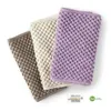 Three kitchen towels in different colors are neatly folded and arranged diagonally. Produktbild-Vorschau