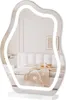 A mirror with integrated LED lighting is displayed on a white stand, reflecting a bedroom scene. Produktbild-Vorschau
