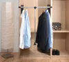 A closet interior with clothes hanging on a rod and a floor lamp. Náhled obrázku produktu