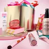 A collection of Sephora beauty products arranged around a large golden advent calendar. Produktbild-Vorschau