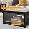 A coffee table in a living room setting, with decorative boxes on the lower shelf. Produktbild-Vorschau