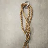A close-up view of a braided rope with metal rings, likely part of a swing or hanging mechanism. Náhled obrázku produktu