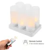 A hand holding a remote control points it towards a set of LED tea lights on a charging base. Produktbild-Vorschau