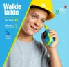 A young boy wearing a yellow hard hat holds a blue and green walkie-talkie. Produktbild-Vorschau